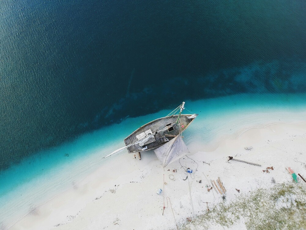 Boat approaching Mnemba Island for snorkeling trip